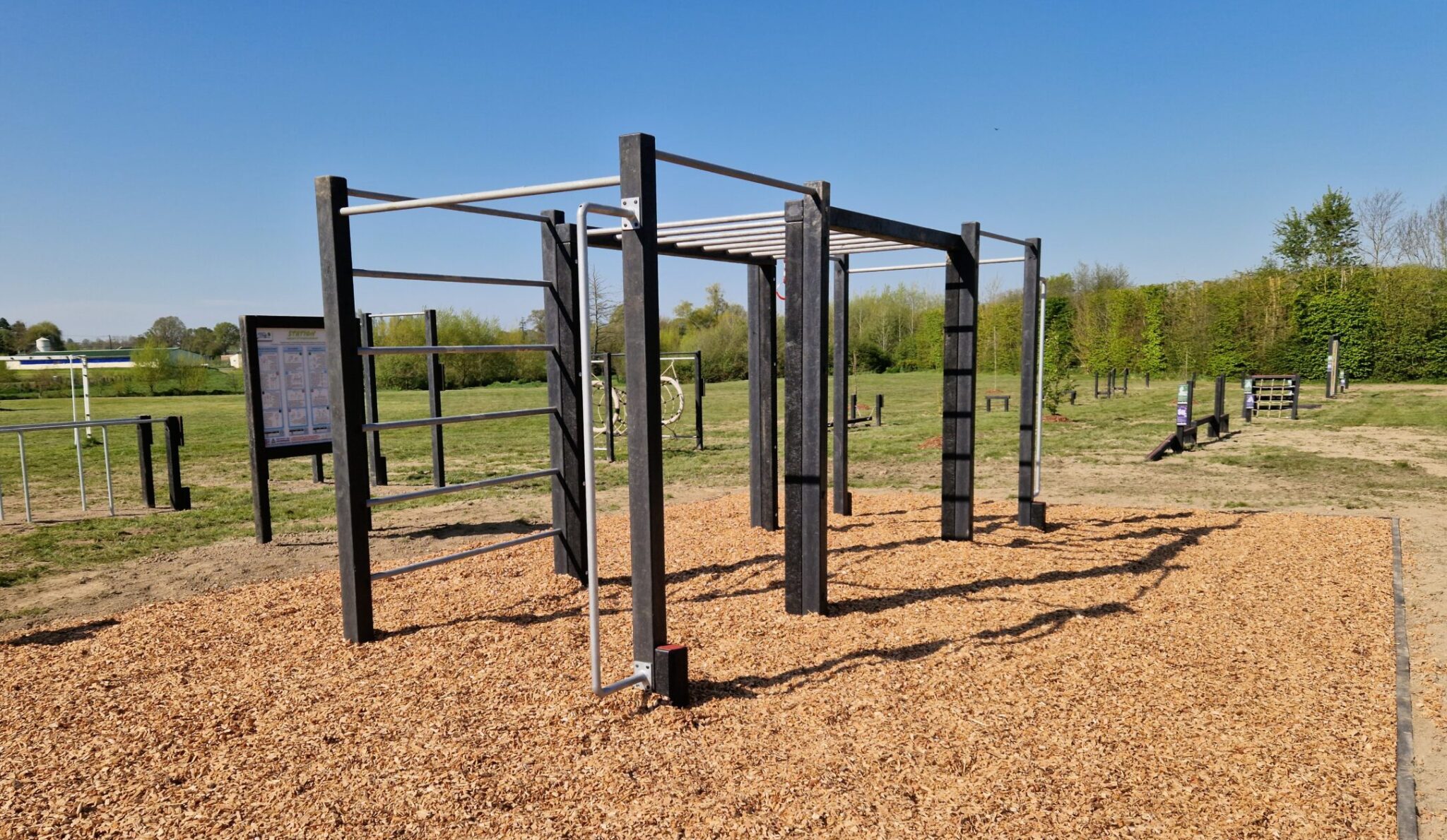 Cette image est une photographie d'une station de fitness en matières recyclées. Elle illustre l'ensemble des équipements sportifs de fitness que Nathis peut fournir et installer aux collectivités de Bretagne.